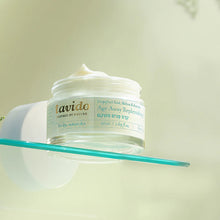 Load image into Gallery viewer, Open jar of Lavido Age Away Replenishing Cream balanced on a glass edge