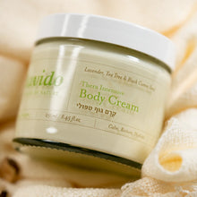 Load image into Gallery viewer, Close-up of a Lavido Thera Intensive Body Cream jar resting on a soft towel