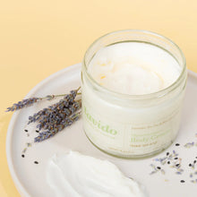 Load image into Gallery viewer, Open jar of Lavido Thera Intensive Body Cream on a plate with dried lavender