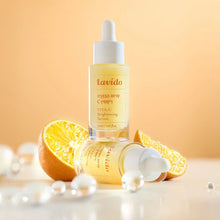 Load image into Gallery viewer, Lavido Vitamin C Brightening Serum bottles with orange slices and water droplets